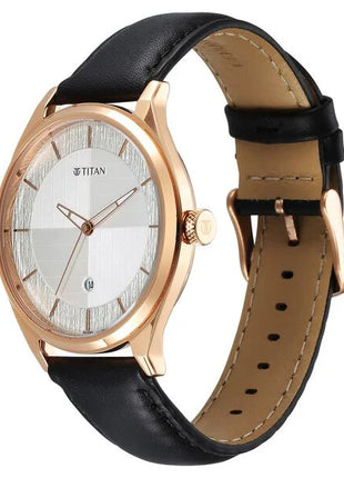 a gold watch with a black leather strap