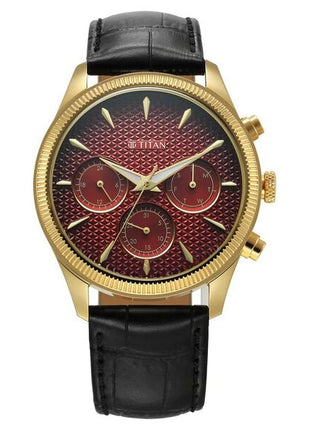 a gold and red watch with a black leather strap