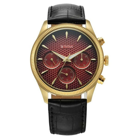 a gold and red watch with a black leather strap