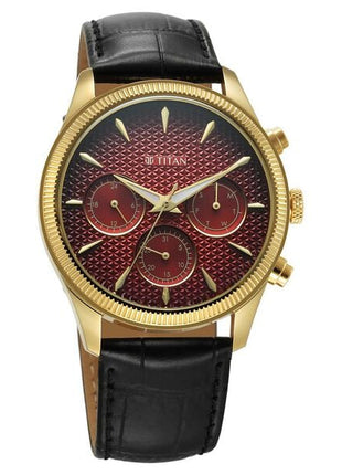 a gold watch with a red face and black leather strap