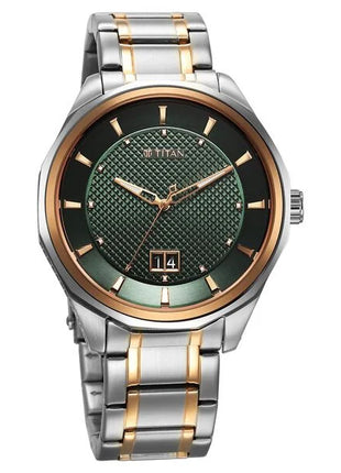 a silver and gold watch with a green dial