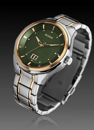 a watch with a green dial on a silver bracelet