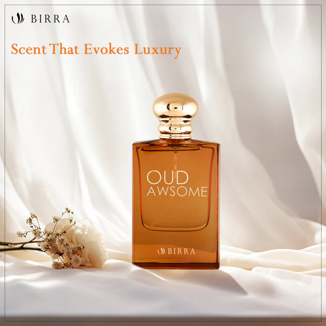 Oud Awsome perfume bottle on a silky background, accompanied by delicate flowers, emphasizing luxury with the text 'Scent That Evokes Luxury'.