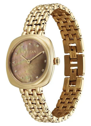 a gold watch with a mother of pearl dial