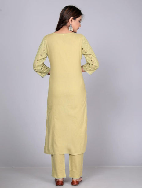 a woman wearing a yellow tunic and pants