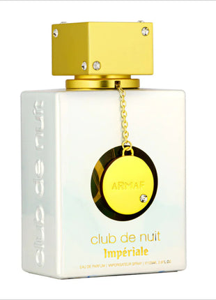 a bottle of perfume with a gold chain around it