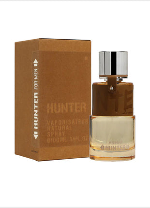 a bottle of hunter cologne next to a cardboard box