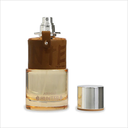 a bottle of perfume sitting next to a metal container