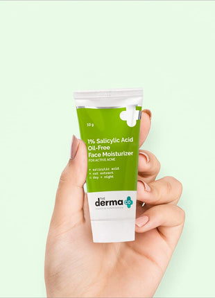 a hand holding a tube of derma the sulsyly acid face moister